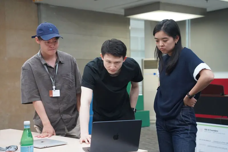 Educators working at a laptop